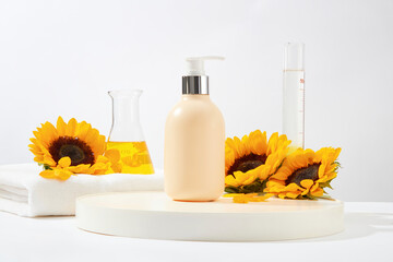 A pink bottle placed in white pedestal on white background, with some lab glassware such as test...