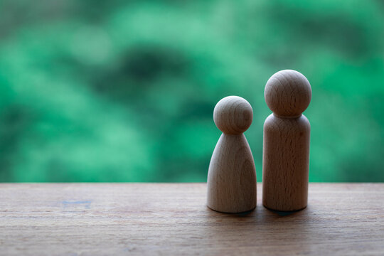 A pair of simple puppets are placed on the windowsill. Warm puppet ornaments.