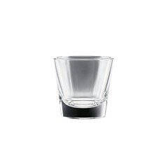 Shot glass small and sturdy containing a clear potent spirit that reflects light like a