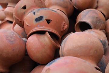 pots are gathered and arranged in a pattern in the empty space. The potter works on a pottery wheel to made of soft colored clay, retro style toned Clay pots with hand and equipment