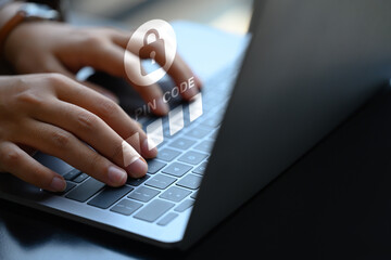 Hands entering pin code on laptop. User privacy security and protect personal data concept