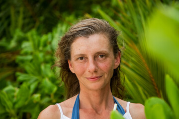 woman portrait and lush tropical greenery