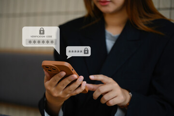 Young businesswoman typing on smartphone entering verification code for login. Cyber security...