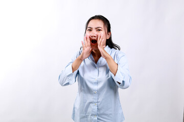 Asian business woman scream to camera by having combined hands in a megaphone isolated on white...