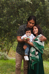 Young family enjoying time together in a garden, copy space.