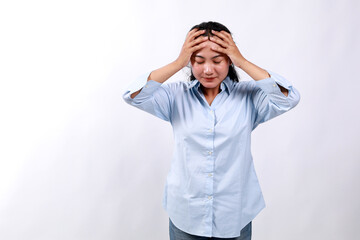 Shock, stress. Young asian woman holding hands on head, posing against white background....