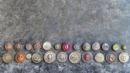 A row of coins with a variety of designs and colors