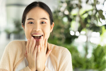 Excited happily laughing asian woman in casual dress, looking at you, concept image of success,...