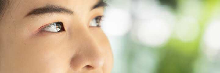Closeup shot of Eyes of Happy and confident asian woman looking up, keeping her eyes open on...