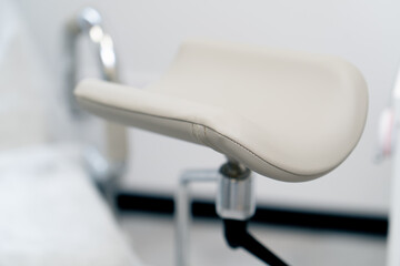 close-up in gynecological office on a chair with a footrest examining a patient