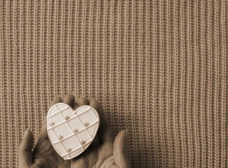 Treasured Love in Sepia Tones. A Heart-Shaped Token Cradled Gently Against a Textured Background