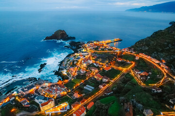 Obraz premium Aerial view of Porto Moniz with volcanic lava swimming pools, night city, Madeira, Portugal