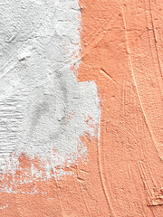 surface of an old wall painted with gray paint over terracotta paint