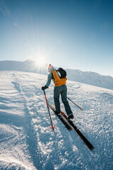 Mountaineer backcountry ski walking ski alpinist in the mountains. Ski touring in alpine landscape...