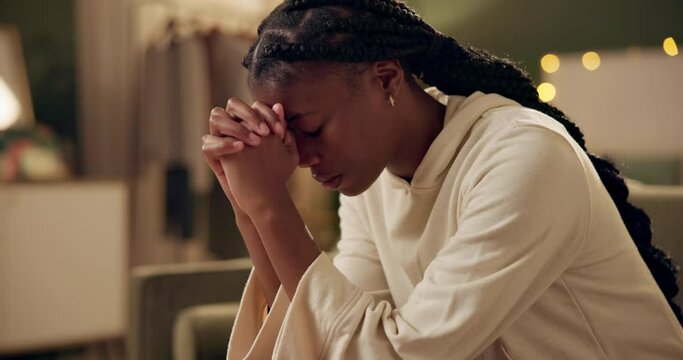 Black girl, worship or pray on sofa in home for solace or devotion, spiritual connection and wellness gratitude to god. Woman, eyes closed and prayer to higher power for praise or hope and christian.