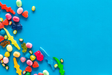 Colorful lollipops and different gummies jelly and candies, top view