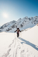 Mountaineer backcountry ski walking ski alpinist in the mountains. Ski touring in alpine landscape...