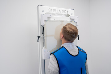 in a private clinic in a white x-ray room a patient prepares for a procedure