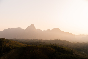 golden sunrise over the defined mountains in Vang Vieng, the adventure capital of Laos