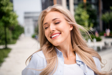 Photo of adorable young blonde hair smiling woman wearing blue shirt satisfaction spring vacation...