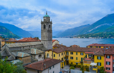 Italy, Bellagio, 22.03.2024: View of the Basilica of St. Giacomo with hona against the backdrop of a mountain landscape and Lake Como 