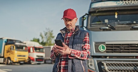 Busy Caucasian male driver chatting on his smartphone with someone about agreement on place of...