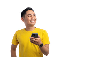 Happy young Asian man holding mobile phone and looking up with big smile isolated on white background