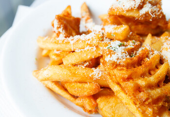 Stack of french fries with cheese on top