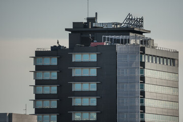 Madrid cityscape with tall urban residential building with dark brick facades and wooden windows at...