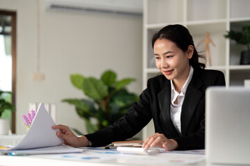 Young business woman asian or employee accounting bookkeeping documents checking financial data or...