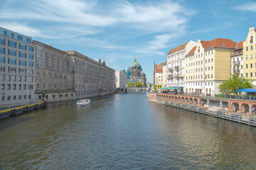 Fototapeta premium City canal with historic buildings and pedestrian bridge, Berlin, Germany, Europe