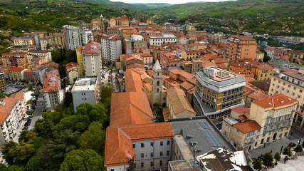 Fototapeta na wymiar Aerial view of Santissima Trinità church and its bell tower located in Potenza, region of Basilicata, Italy. It is a Romanesque-style Roman Catholic church in historic center of the city.