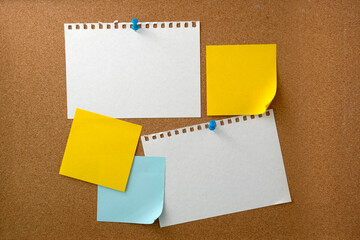 Blank sticky note paper on cork board wall. Noticeboard to organize life and work concept