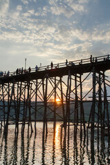 Silhouette of Auttamanusorn Wooden bridge(Saphan mon) in sunset time