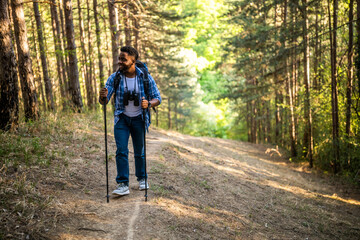 Young man enjoys hiking in nature.