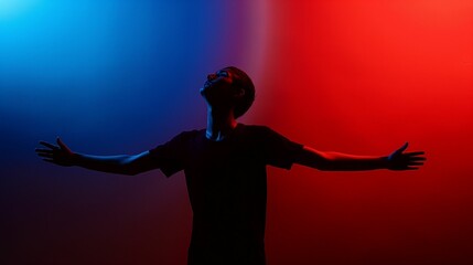 Silhouette of a person with arms raised against red and blue gradient background.