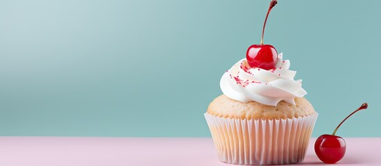A cupcake adorned with white buttercream decorative icing and a cherry atop it Perfect copy space image - obrazy, fototapety, plakaty