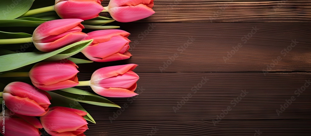 Aufkleber A beautiful arrangement of tulips is placed on a wooden table creating an appealing border design It is perfect for a copy space image