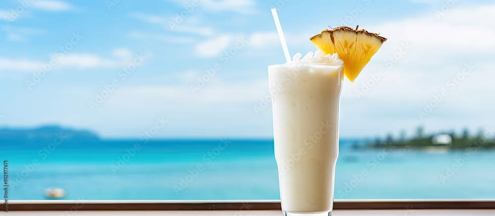 Poster a delicious pina colada cocktail placed on a wooden table with the mesmerizing ocean backdrop provid