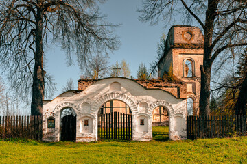The entrance arched gate in front of the picturesquely crumbling church. Selected Focus