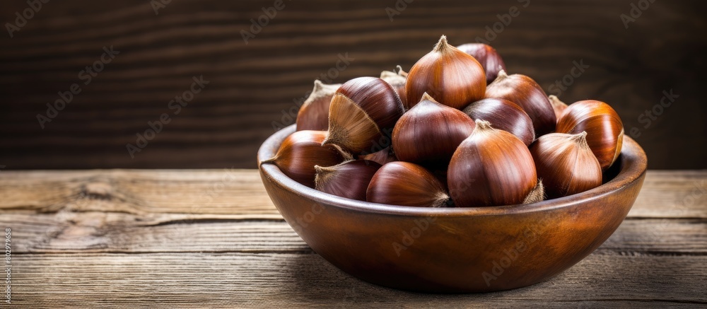 Poster A copy space image showcasing a bowl of fresh chestnuts placed on a rustic old wooden backdrop