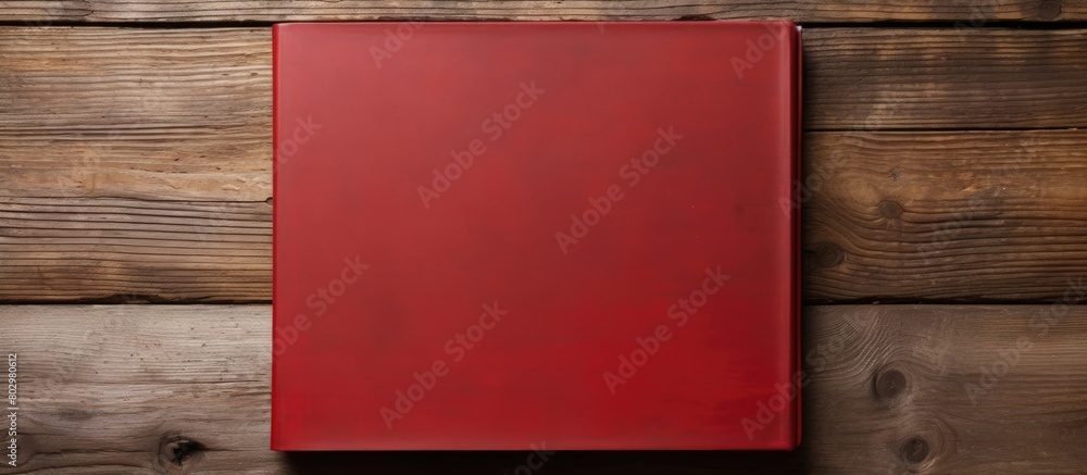 Aufkleber A copy space image of a red notebook placed on a rustic wooden surface