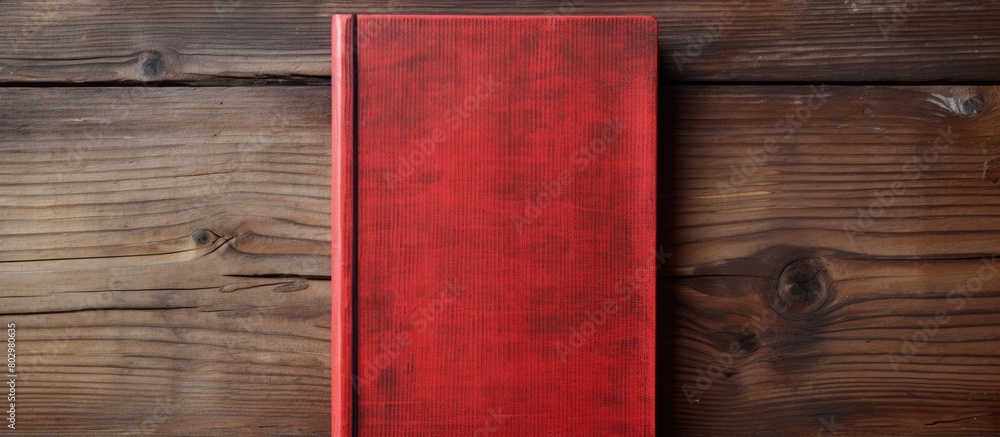 Poster A copy space image of a red notebook placed on a rustic wooden surface