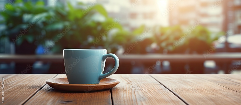 Poster A cup of coffee on a wooden table in the workplace representing the concept of working outside the office. with copy space image. Place for adding text or design