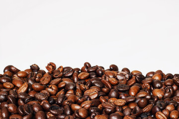 Roasted coffee beans in a placer, a lot of beans lies and levitates, isolated, on a white background