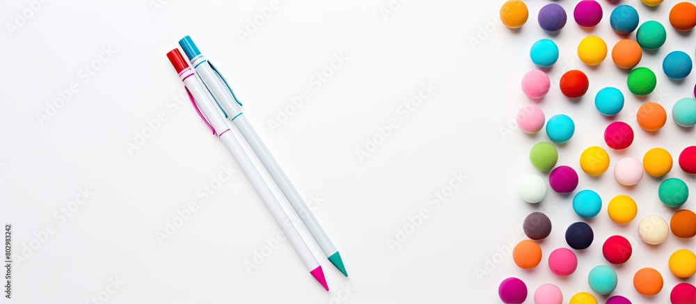 Poster a copy space image of a silver ballpen placed on a white background surrounded by colorful pastel st
