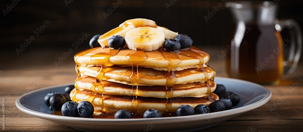 Aufkleber a breakfast of fluffy pancakes topped with banana blueberries and maple syrup displayed on a wooden 