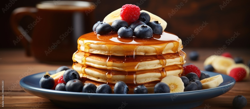Aufkleber a breakfast of fluffy pancakes topped with banana blueberries and maple syrup displayed on a wooden 