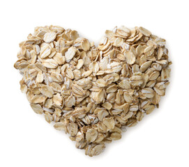 Heart shaped oat flakes on a white background. Top view