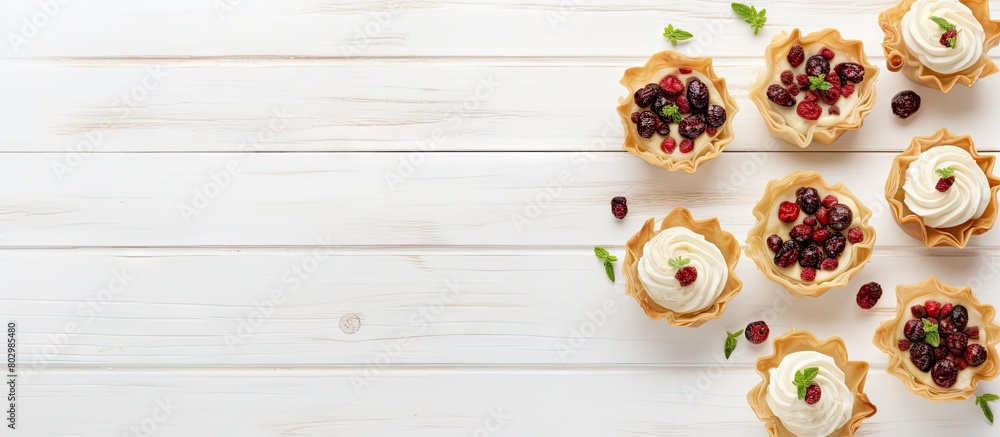 Poster a festive assortment of phyllo pastry appetizers featuring cranberries and baked brie arranged on a 